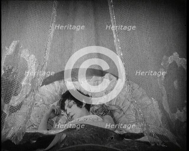 Scene from a 1920s Film. A Female Actor Sleeping in a Bed, 1920s. Creator: British Pathe Ltd.