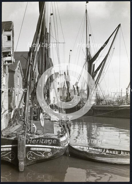 Sailed fishing vessels moored beside timber warehouses at Rochester, Medway, 1925-1935. Creator: J Dixon Scott.