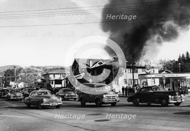 Fire in building causing traffic to slow, Glendale, Burbank, California 1951. Creator: Unknown.