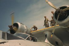 Working on a plane at the Naval Air Base, Corpus Christi, Texas, 1942. Creator: Howard Hollem.