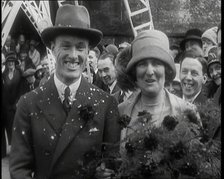 Male Civilian (Groom) And Female Civilian (Bride) Emerging from a Church To Walk Through an...,1920s Creator: British Pathe Ltd.