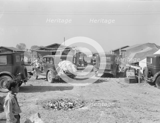 Housing for migratory workers in cotton, five miles north of Corcoran, California, 1936. Creator: Dorothea Lange.