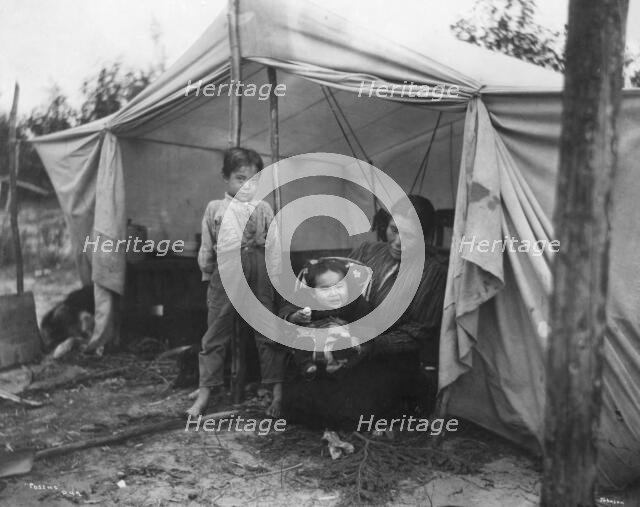 Indian children and mother at entrance of tent, between c1900 and 1927. Creator: Unknown.