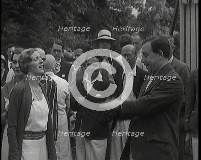 John Bonyton Priestley Tosses a Coin With Gladys Cooper, 1920s. Creator: British Pathe Ltd.