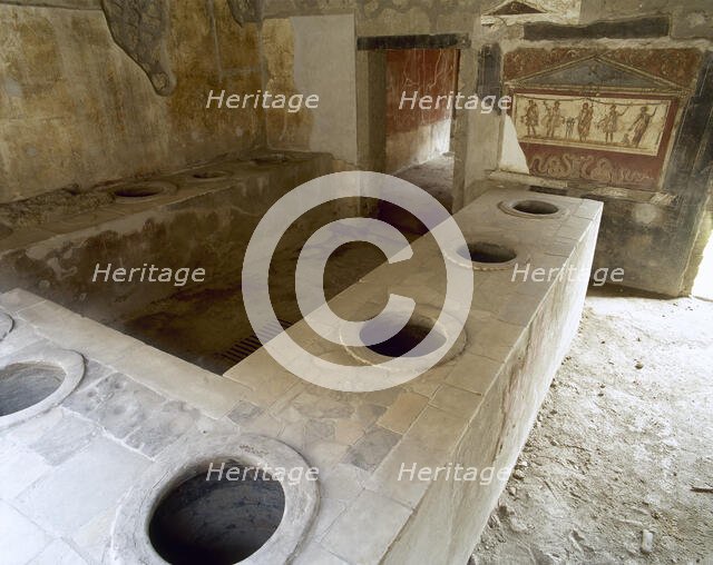 Bar counter with holes to place the amphorae, Thermopolium of Asellina, Pompeii, Italy (2002). Creator: LTL.