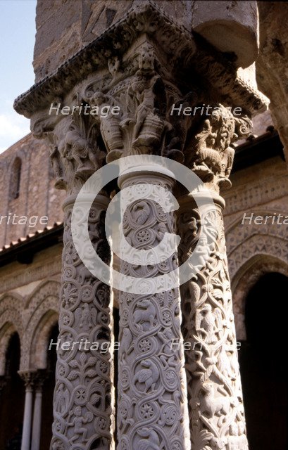 Capitals and carved columns in the Monreale Cathedral cloister in Sicily. The cathedral is Norman…