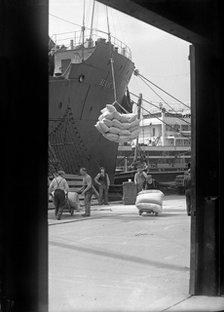 Sacks being loaded onto a ship in London docks, c1945-c1965. Artist: SW Rawlings