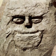 Stone head from pagan Celtic shrine at Cinderford, Gloucestershire. Artist: Unknown