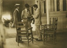Two Japanese men and one American(?) man, probably journalists, conversing on the veranda..., 1905. Creator: Unknown.