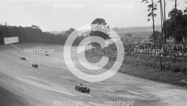 Austin 7 of Charles Goodacre and MG C of the Earl of March, BRDC 500 Mile Race, Brooklands, 1931. Artist: Bill Brunell.
