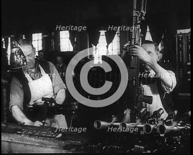 Two Men Making Machine Guns in a Factory, 1940. Creator: British Pathe Ltd.