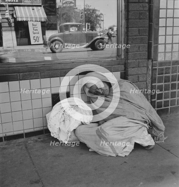 She awaits the international streetcar at a corner in El Paso, Texas to return across..., 1938. Creator: Dorothea Lange.