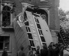 People Standing Next to a Bombed Out Bus, 1940. Creator: British Pathe Ltd.