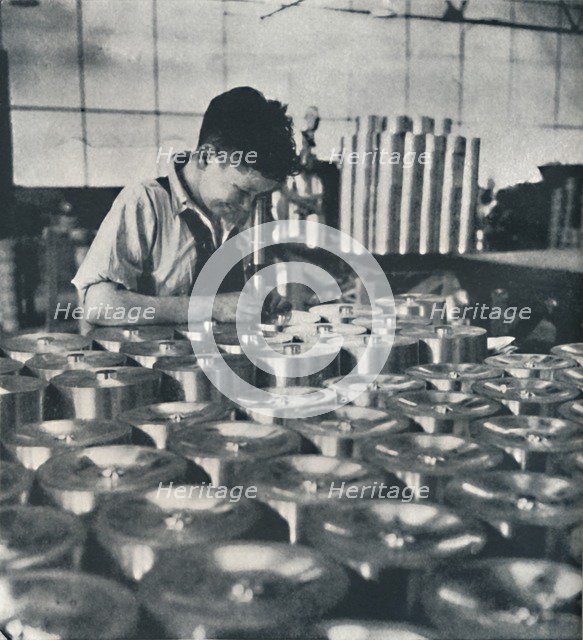 'Apprentice with microscope (testing the hardness of pistons)', 1941. Artist: Cecil Beaton.