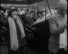 Male Civilian And Female Civilian Standing in Front of an Airplane Putting On an Aviator's..., 1927 Creator: British Pathe Ltd.