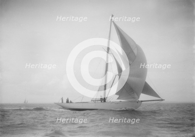 The cutter 'Westwind' sailing with spinnaker, 1912. Creator: Kirk & Sons of Cowes.