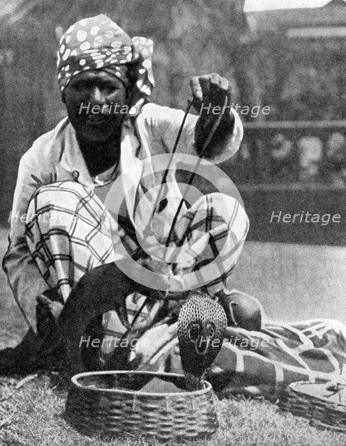 Indian snake charmer with mongoose and cobra, 1936. Artist: Fox