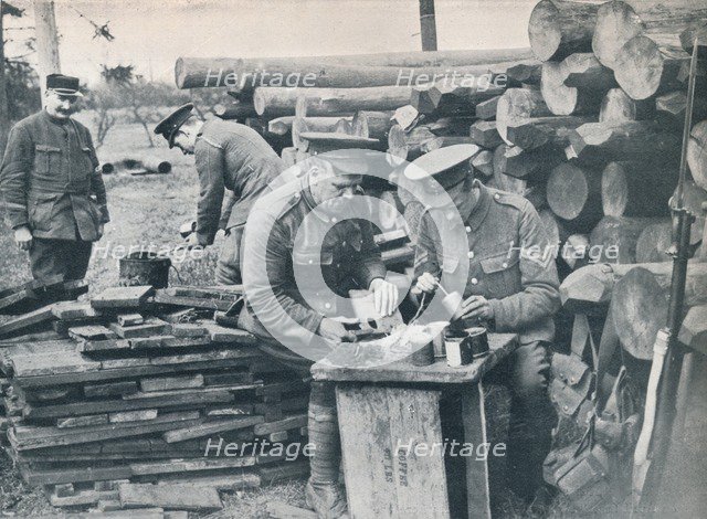 British engineers with the Expeditionary Force making hand grenades out of tobacco tins, c1914. Artist: Unknown