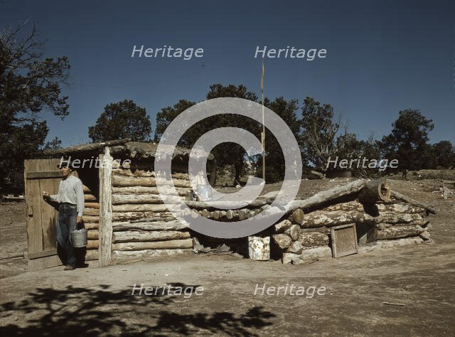 Mr. Leatherman, homesteader, coming out of his dugout home, Pie Town, New Mexico, 1940. Creator: Russell Lee.