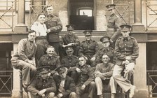 Soldiers posing for a group portrait outside a large building, c1910s. Creator: Unknown.