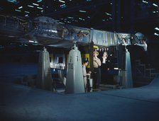 Working on wing of Consolidated Liberator..., Consolidated Aircraft Corp., Fort Worth, Texas, 1942. Creator: Howard Hollem.