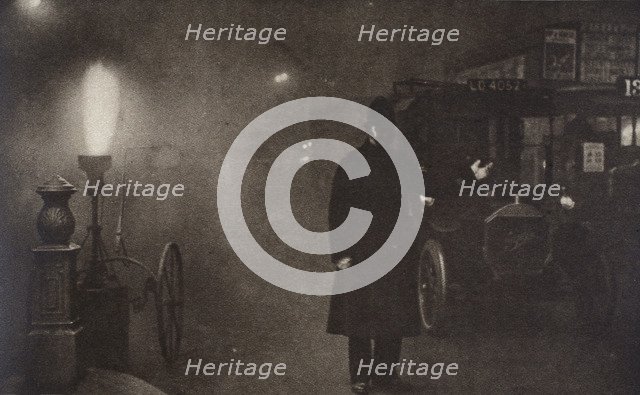 A constable directing traffic in the fog, London, c1910s-c1920s(?). Artist: Unknown