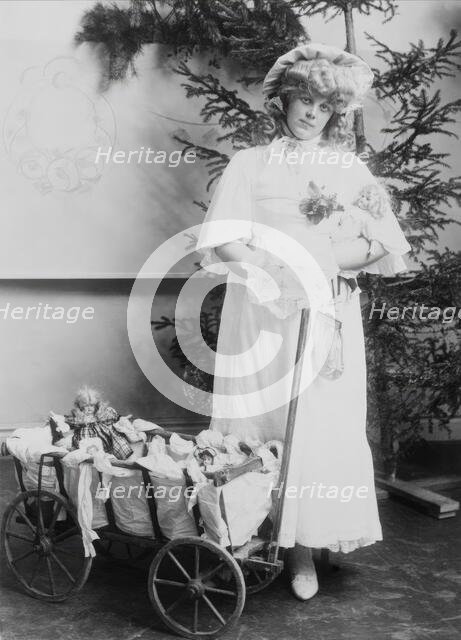 Girl with dolls and doll carriage, 1900.  Creator: Unknown.