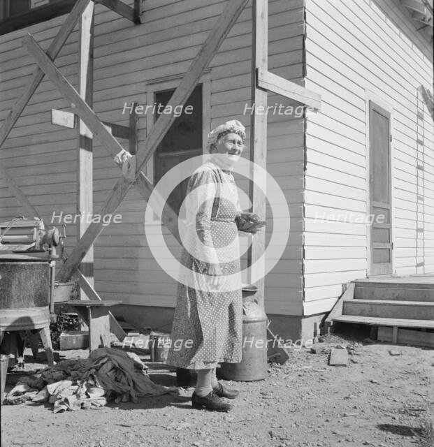 Soper grandmother helps the large family, Willow Creek area, Malheur County, Oregon, 1939. Creator: Dorothea Lange.