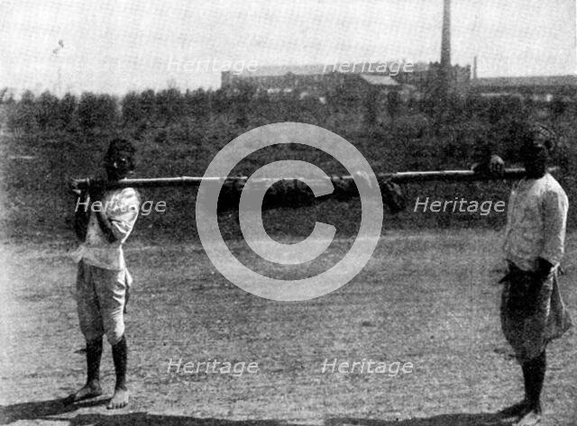 Scenes in Plague-Stricken Bombay: removing body of a...child to the...burning-ground, 1898. Creator: Gysi.