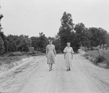 Women walking down the road to see a sick neighbor, Person County, North Carolina, 1939. Creator: Dorothea Lange.