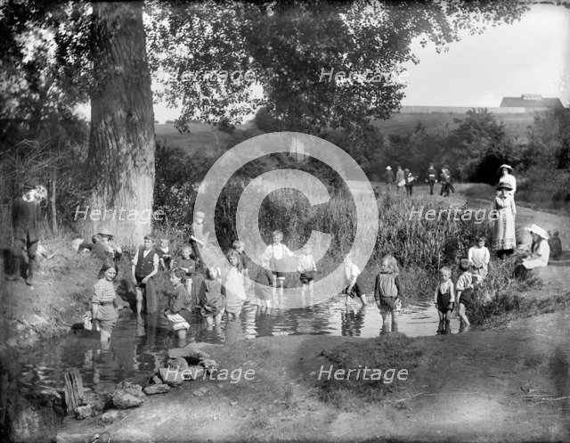 Children playing in a pool on a hot summer's day, Cowley, Oxford, Oxfordshire, 1914.  Artist: Henry Taunt