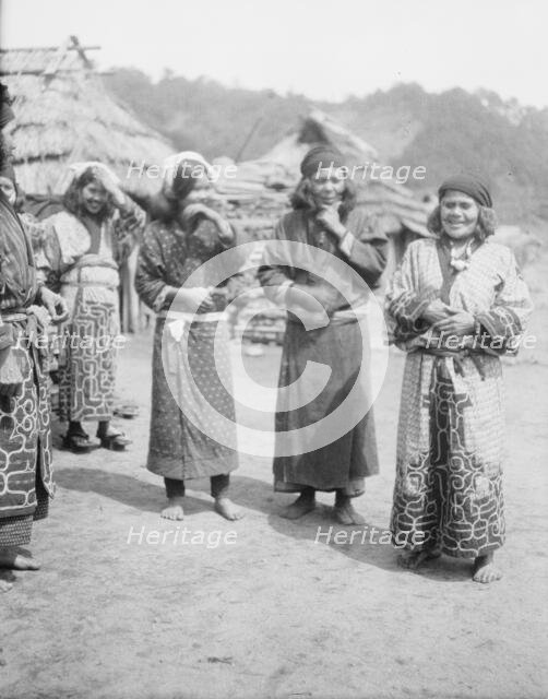 Ainu woman outside in the village lane, 1908. Creator: Arnold Genthe.