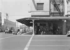 Street corner of San Joaquin Valley town on U.S. 99 showing secondhand store, Fresno, CA, 1939. Creator: Dorothea Lange.