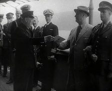 Winston Churchill Handing Franklin D. Roosevelt a Piece of Paper, 1941. Creator: British Pathe Ltd.