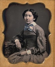 Seated Young Woman Wearing Collar with Large Bow, Resting Arm on Table, 1850s. Creator: Unknown.