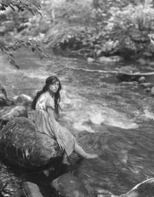 Cowan, Rosamonde, Miss (Rose Rolanda ; Mrs. Miguel C.), seated by a stream, 1919 May 24. Creator: Arnold Genthe.