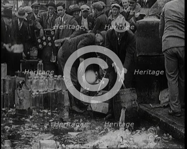 Prohibition Scenes in the United States of America. Men Smashing Bottles of Alcoholic..., 1920. Creator: British Pathe Ltd.