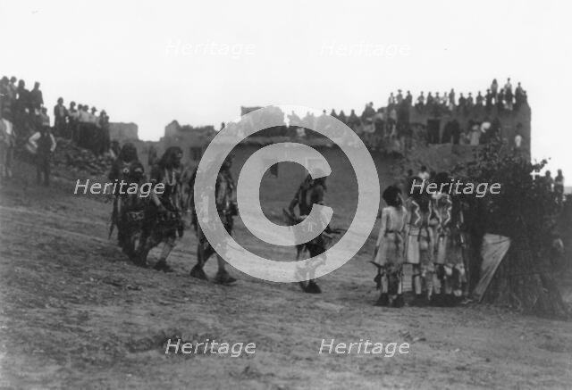 Snake dancers entering the plaza, c1905. Creator: Edward Sheriff Curtis.
