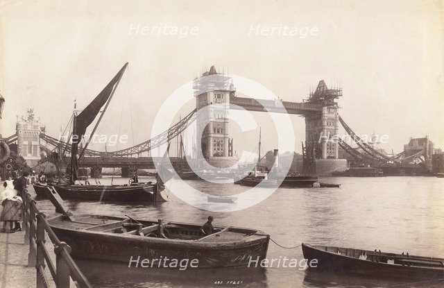 View of Tower Bridge under construction with river traffic in the foreground, London, c1893. Artist: Unknown