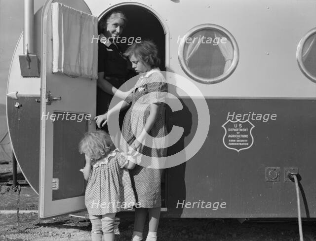 Young mother brings her child to the trailer clinic..., FSA, Merrill, Klamath County, Oregon, 1939. Creator: Dorothea Lange.