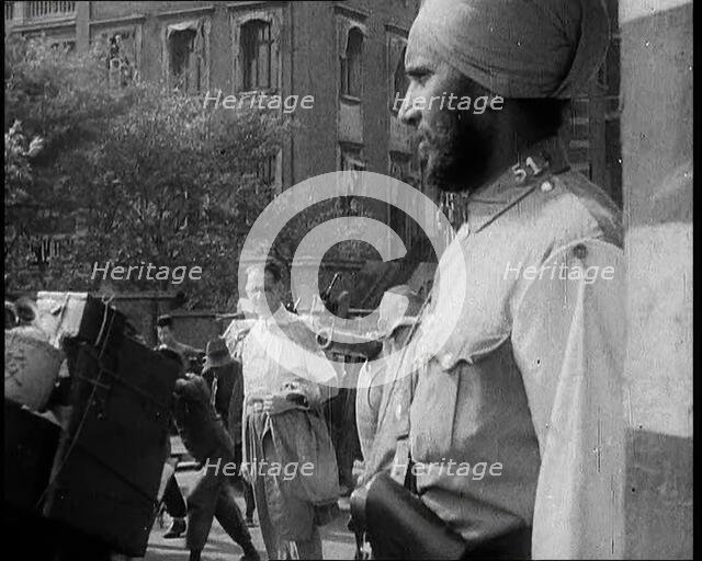Indian Soldier in the International Settlement in Shanghai With Civilian..., 1937 Creator: British Pathe Ltd.