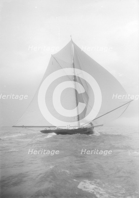 The gaff rigged cutter 'Bloodhound' sailing downwind under spinnaker, August 1912. Creator: Kirk & Sons of Cowes.