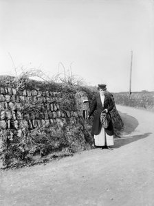 Postwoman emptying a postbox at an unidentified location in Kerrier, Cornwall, 1901. Artist: Alfred Newton & Sons.