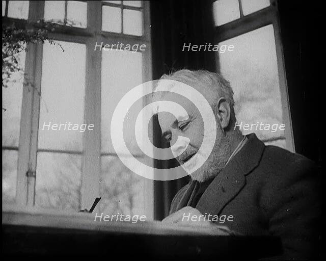 C.E.M Joad Sitting Down at His Desk, 1930s. Creator: British Pathe Ltd.