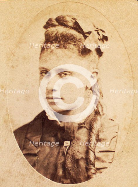 Oval portrait of unidentified young woman with long curl draped over chest. c1880-c1889. Creator: Unknown.