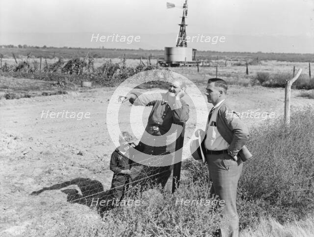 Rural rehabilitation client talking with county supervisor, FSA, Tulare County, California, 1938. Creator: Dorothea Lange.