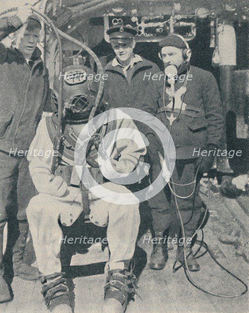 'American Naval Diver wears three-fingered watertight rubber gloves', 1937. Artist: Unknown.