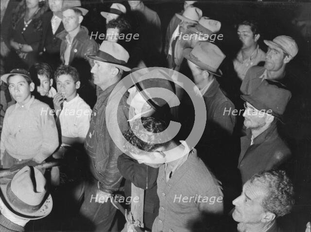 Street meeting at night in Mexican town outside of Shafter, California, 1938. Creator: Dorothea Lange.
