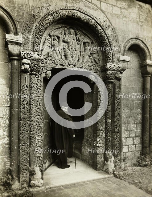 Ely Cathedral: Prior's Door, with Bedesman, 1891. Creator: Frederick Henry Evans.