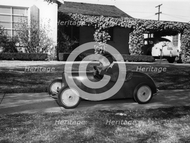Boy in a pedal car. Artist: Unknown